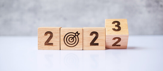 hand flip 2022 to 2023 block with dartboard sign. Business Goal, Target, Resolution, strategy,...