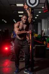 Fototapeta na wymiar Strong shirtless muscular handsome man. Topless macho bodybuilder posing in gym.