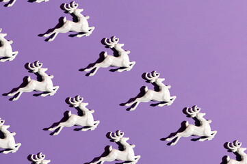 Reindeer Christmas decoration, creative pattern on a purple background. 