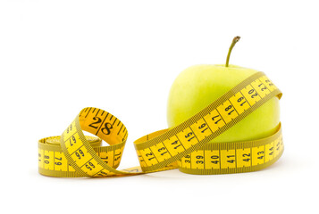 Healthy lifestyle concept. Green apple with measuring tape isolated on white background