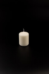 White candles on dark background. Close-up, copy space.