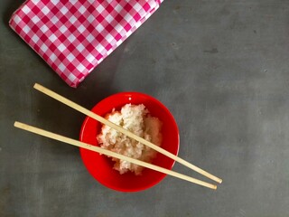 chopsticks,  rice and napkin on black background 