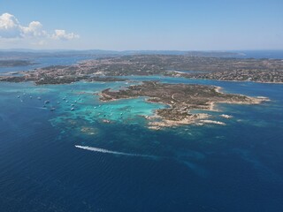 Plakat Aerial view of La Maddalena Island, Isola Giardinelli with the drone view of Caprera Island in Sardegna, Italy. Birds eye view of crystalline and turquoise water in north Sardinia, luxury yacht, boat.