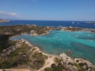 Obraz premium Aerial view of La Maddalena Island, Isola Giardinelli with the drone view of Caprera Island in Sardegna, Italy. Birds eye view of crystalline and turquoise water in north Sardinia, luxury yacht, boat.