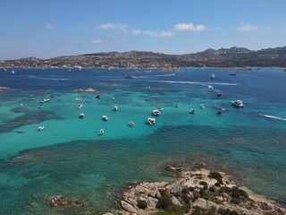 Aerial view of La Maddalena Island, Isola Giardinelli with the drone view of Caprera Island in Sardegna, Italy. Birds eye view of crystalline and turquoise water in north Sardinia, luxury yacht, boat.