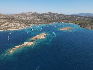 Aerial view of La Maddalena Island, Isola Giardinelli with the drone view of Caprera Island in Sardegna, Italy. Birds eye view of crystalline and turquoise water in north Sardinia, luxury yacht, boat.