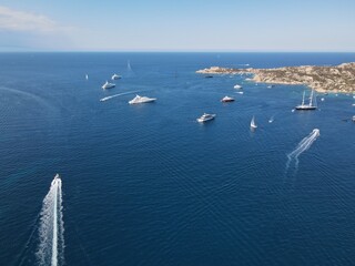 Aerial view of La Maddalena Island, Isola Giardinelli with the drone view of Caprera Island in Sardegna, Italy. Birds eye view of crystalline and turquoise water in north Sardinia, luxury yacht, boat.