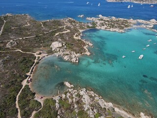 Aerial view of La Maddalena Island, Isola Giardinelli with the drone view of Caprera Island in Sardegna, Italy. Birds eye view of crystalline and turquoise water in north Sardinia, luxury yacht, boat.