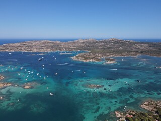 Aerial view of La Maddalena Island, Isola Giardinelli with the drone view of Caprera Island in Sardegna, Italy. Birds eye view of crystalline and turquoise water in north Sardinia, luxury yacht, boat.