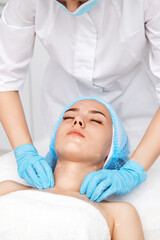 Fototapeta na wymiar young beautiful woman receiving facial massage. spa