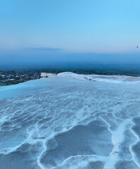 Fototapeta premium Pamukkale Travertines Cinematic Aerial Drone footage. Turkish famous white thermal bath with healthy clean water in a beautiful sunset.