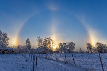 Winter day with Sun halo and sun dogs in the countryside
