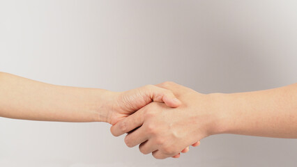 Handshake gesture on white background.