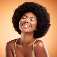 Black woman face, natural beauty and skincare health wellness on orange studio wall background. A happy african model smile, black female empowerment and healthy cosmetic luxury fashion afro haircare