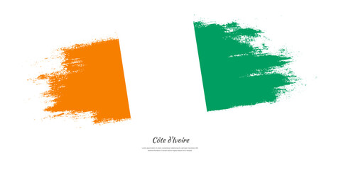 Happy Independence Day of Cote dIvoire. National flag on artistic stain brush stroke background.