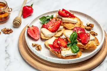 Bruschetta Sandwich with sstrawberries, cheese camembert nuts and honey basil, served as an appetizer