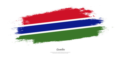 Happy Independence Day of Gambia. National flag on artistic stain brush stroke background.