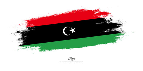 Happy Independence Day of Libya. National flag on artistic stain brush stroke background.