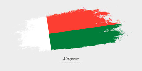 Happy Independence Day of Madagascar. National flag on artistic stain brush stroke background.