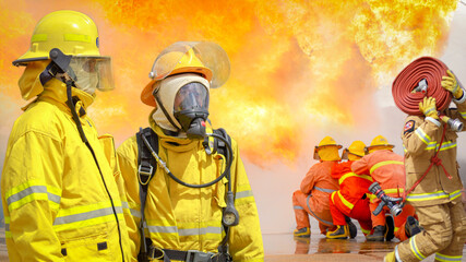 Fireman,Firefighter training Firefighters using water and fire extinguishers to fight the flames in...