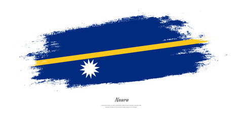 Happy Independence Day of Nauru. National flag on artistic stain brush stroke background.
