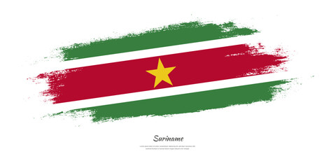 Happy Independence Day of Suriname. National flag on artistic stain brush stroke background.