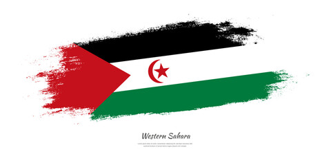 Happy Independence Day of Western Sahara. National flag on artistic stain brush stroke background.