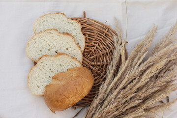 Sliced wheat bread on a stand. Rustic table.