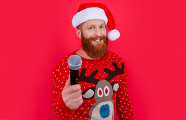 christmas music party. cheerful man at christmas music party with microphone, selective focus.