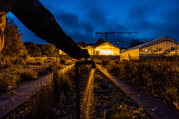 Naklejka premium Copenhagen, Denmark A water faucet at a greenhouse at night.