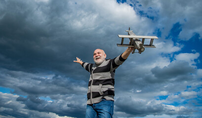 happy retirement. old-aged granddad with toy. retired old man outdoor. senior man at retirement