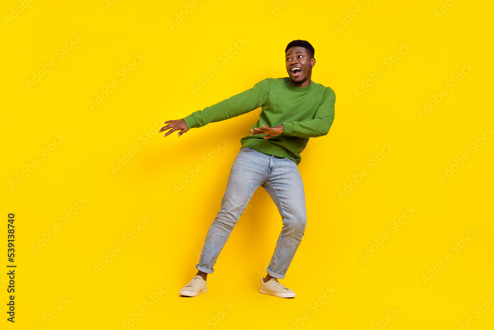 Wall mural Full length body size view of attractive funky cheerful guy dancing moving isolated on bright yellow color background - Wall murals