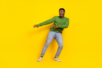 Fototapeta na wymiar Full length body size view of attractive funky cheerful guy dancing moving isolated on bright yellow color background