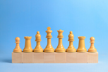 Chess pieces on wooden blocks.