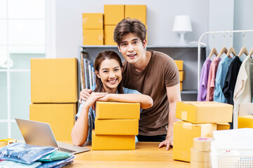 Young Asian couple business working in house office look like doing startup business and smiling happy and positive,Surprise of couple success on making big sale of his online store.