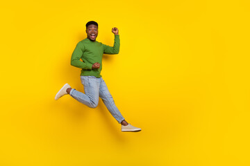 Fototapeta na wymiar Full length body size view of attractive lucky cheery comic guy jumping rejoicing isolated over vivid yellow color background