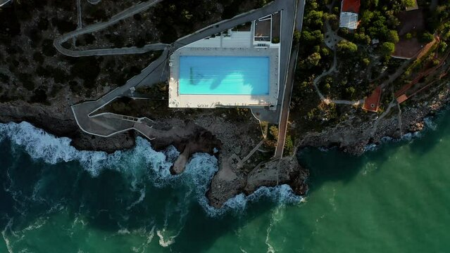 Top View Of Seafront Pool At The Luxury Hotel Resort Of Perla del Golfo In Terrasini, Palermo, Sicilia, Italy. Aerial Topdown Shot