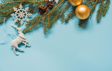 christmas background - pine tree branches, presents and decor on blue copy space background