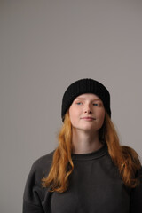 young girl model in black cap and coat isolated on grey background. Product photo mockup for fashion brands and marketplaces.