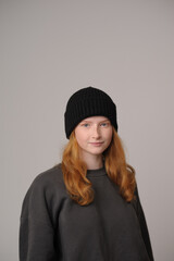 young girl model in black cap and coat isolated on grey background. Product photo mockup for fashion brands and marketplaces.