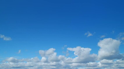 Beautiful cirrus and cumulus on different layers clouds. Daytime sky with cirrus clouds. Cirrus clouds in a blue sky depicting mare s tails. Timelapse.