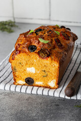Savoury cake with tomatoes, olives and feta cheese
