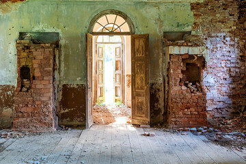 inside interior of an old abandoned church in Latvia, Galgauska, entrance door and damaged brick wall