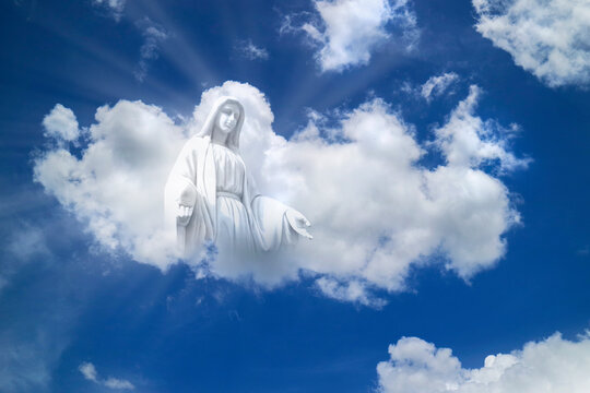 Mary statue on white clouds sky  with light ray at heaven. culture and religion concept,.