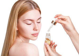 Cosmetics serum in bottle near face of young woman.