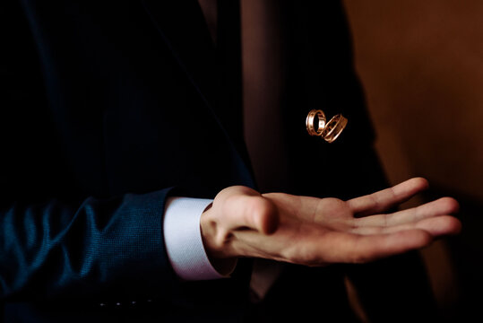 Human hand holding a ring inside on white background