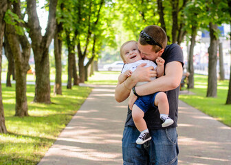 Fototapeta premium Father and son in the park. Close-up. Happy fatherhood, summer park. Father's Day concept