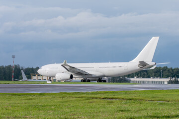 Fototapeta na wymiar White unmarked passenger jet waiting for permission to take off. White aircraft on the runway.