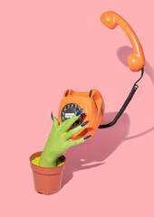 Halloween creative layout with witch hand  growing from flower pot and dial retro phone on pastel...