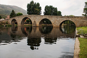 Fototapeta na wymiar Old stone bridge over river